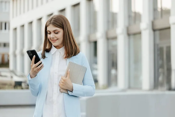 Smiling Caucasian Woman Wearing Formal Suit Using Mobile Phone Typing — Stock Photo, Image