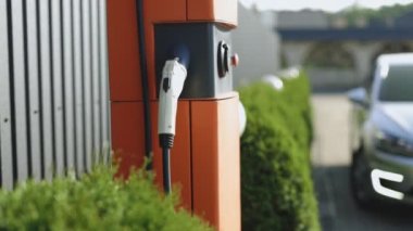 Charge station for electric cars. Electric car charger. Alternative energy for ecological cars. Electric, zero pollution cars on green energy concept on modern city parking lot.