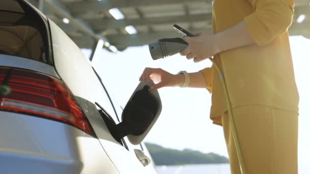 Woman Plugging Electric Car Outlet Socket Activates Charging App Phone — 비디오