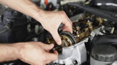 Auto Mechanic Working on Car Engine in Garage. Repair service. Auto Car Mechanic Workshop Repair Car Engine. Internal Combustion Engine Parts.