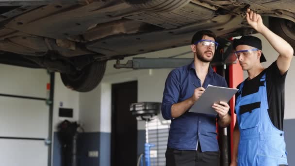 Car Service Employees Inspect Bottom Skid Plates Car Manager Checks — Vídeo de Stock
