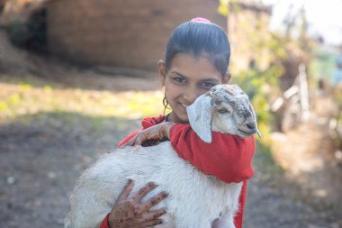 Uttarakhand yakınlarındaki köyde keçi tutan Hintli bir kızın portresi.