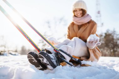 Kış karlı ormanlarda mutlu bir kadın kızağın üstünde yuvarlanıyor. Kış doğasında eğlenmek. Tatiller, dinlenme, seyahat konsepti.