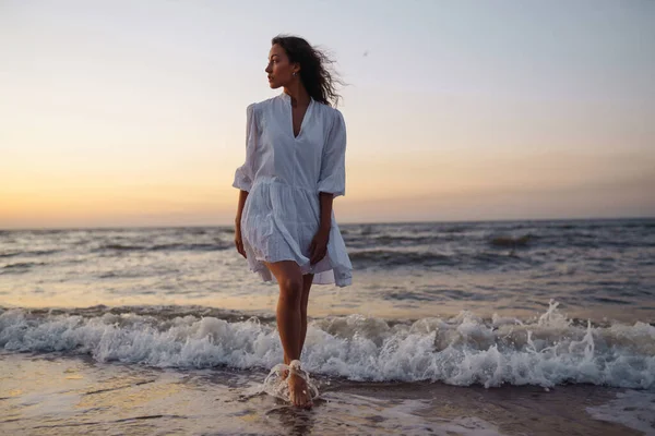 穿着雅致的白色衣服 穿着时髦的女人在海边摆姿势 夏天的时候旅行 放松和生活方式概念 — 图库照片