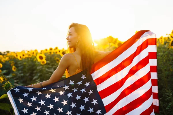 Ung Kvinna Håller Stolt Den Amerikanska Flaggan Solrosfältet Patriot Hissar — Stockfoto