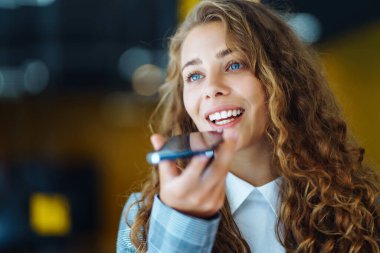 Female customer service representative in a headset is consulting clients online. Call center and business people concept