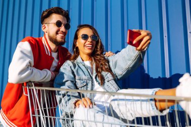 Selfie zamanı. Genç arkadaşlar cep telefonlarıyla fotoğraf çekiyorlar. Akıllı telefon kamerasıyla. Alışveriş zamanı. Blog yazıyorum. Alışveriş, müşteri, satış konsepti.