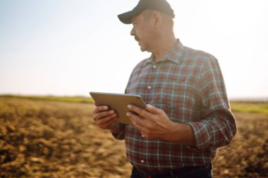 Farmer is checking soil quality before sowing. Agriculture, gardening or ecology concept.