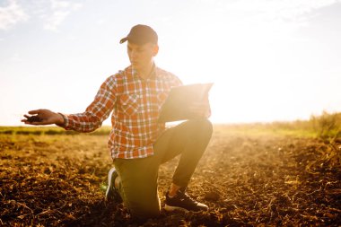 Farmer is checking soil quality before sowing. Agriculture production concept.