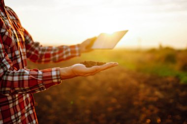 Farmer is checking soil quality before sowing. Agriculture production concept.