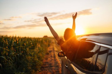 Towards adventure! Young woman is resting and enjoying the trip in the car.  Lifestyle, travel, tourism, nature, active life.
