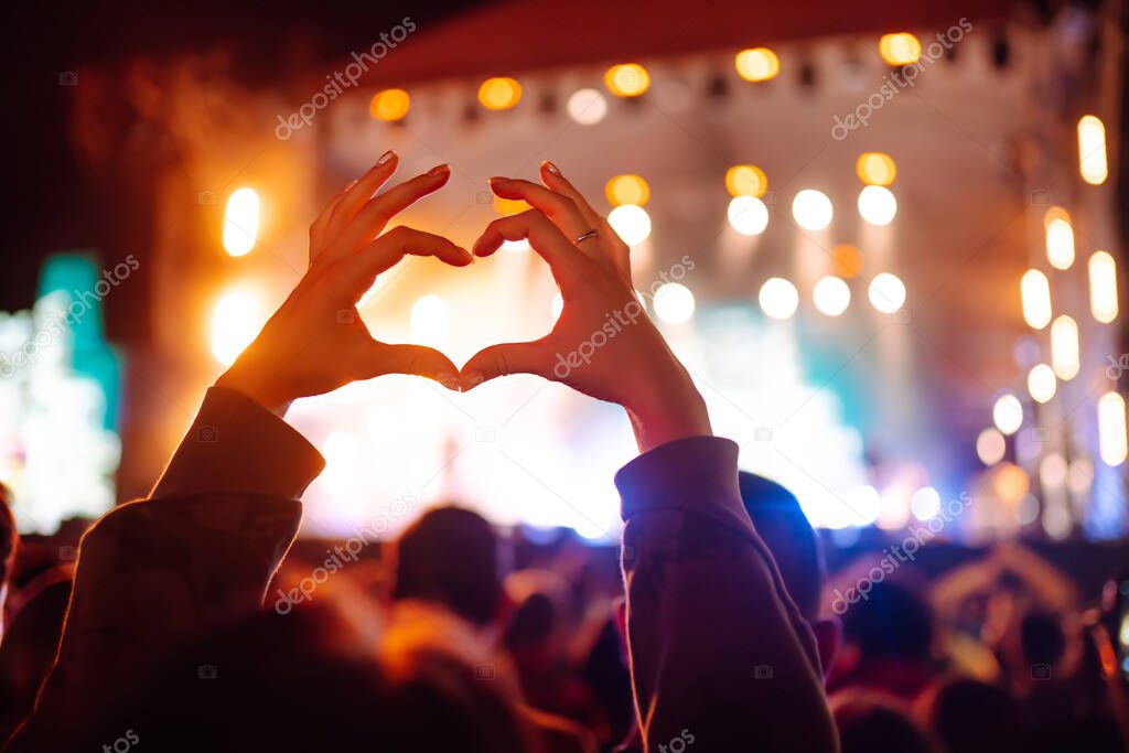 rowd with raised hands at music festival. Summer holiday, vacation concept.