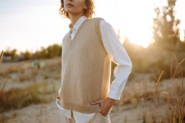 Stylish woman enjoying autumn weather outdoor. Fashion, style concept. People, lifestyle, relaxation and vacations concept.