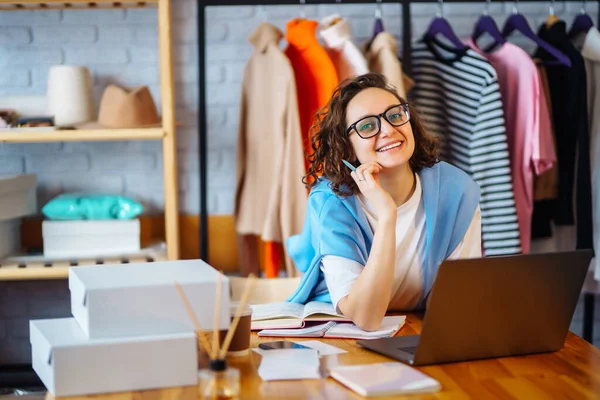 Small business owner, entrepreneur, seller with laptop analyze sales, new orders to be sent and check stocks. Online sales.