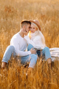 Young couple having fun walking and hugging n the park. Autumn weather. Relaxation, youth, love, lifestyle concept.