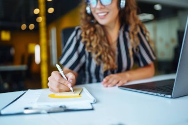 Education and working online. Young woman with glasses working on laptop. Technology, Freelance, online course, remote work and lifestyle concept.