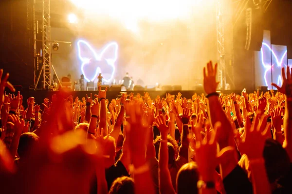 rowd with raised hands at music festival.  Youth, party, vacation concept.