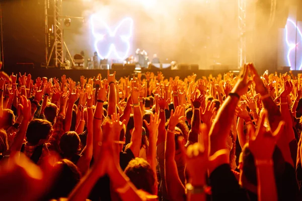 rowd with raised hands at music festival.  Youth, party, vacation concept.