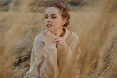 Stylish woman enjoying autumn weather outdoor. Fashion, style concept. People, lifestyle, relaxation and vacations concept.