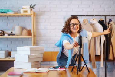 Genç kadın blogcu takipçilerle konuşuyor, canlı yayında vlog için yeni moda videoları kaydediyor. nline store, küçük işletme sahibi, satıcı, girişimci.