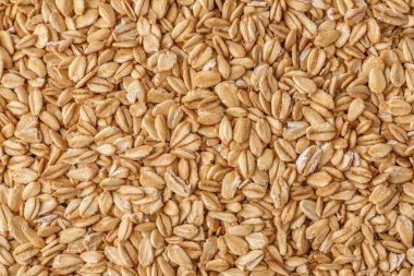 Yuvarlak yulaf, yulaf ezmesi arka plan veya doku. Yaklaş, tam üstte. Kuru yulaf yığını izole edilmiş..