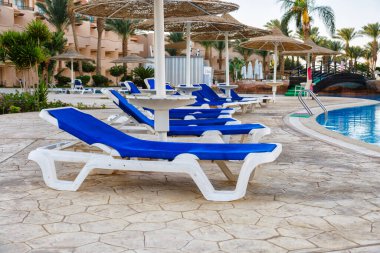 Hurghada, Egypt. Egyptian garden with palm trees in hotel .Swimming pool and accommodation at tropical resort. Buildings, swimming pools and a recreation area by the red sea. All iclusive holidays.