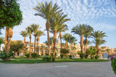 Hurghada, Egypt. Egyptian garden with palm trees in hotel .Swimming pool and accommodation at tropical resort. Buildings, swimming pools and a recreation area by the red sea. All iclusive holidays.
