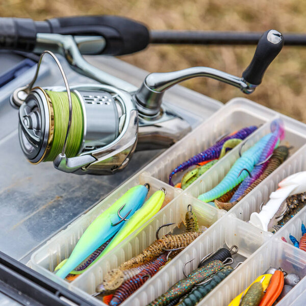 A large fisherman's tackle box fully stocked with lures and gear for fishing.fishing lures and accessories. fishing spinning. Kit of fishing lures.