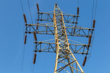 Yüksek voltaj postası. Yüksek voltajlı gökyüzü arka planı. Elektrik konsepti, yüksek voltajlı elektrik iletim pilonu siluetli kule.