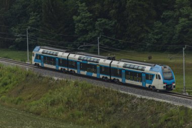 Trains in deep valley of river Sava near Radovljica town in summer Slovenia