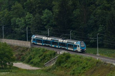 Trains in deep valley of river Sava near Radovljica town in summer Slovenia