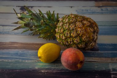 Egzotik renkte taze meyve eski mavi masada, gün ışığında.