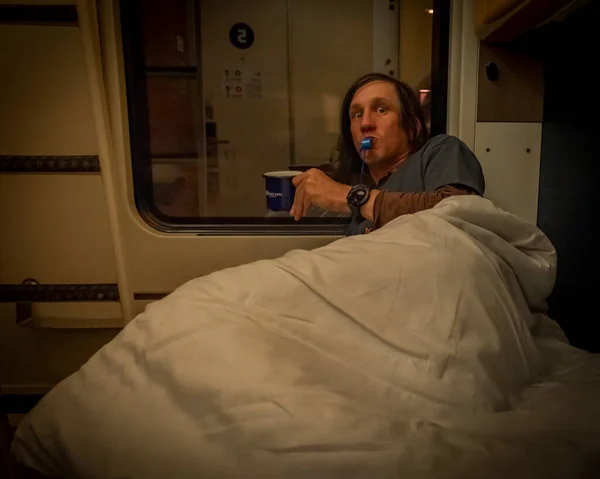 Man before sleeping in compartment of sleeping coach from Prague to Slovakia in summer night