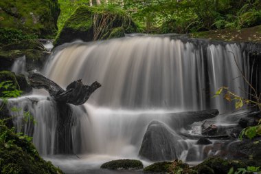 Waterfall under floodgate near Vyssi Brod town in cloudy summer fresh day