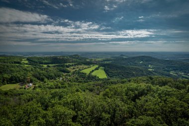 View from Varhost hill and lookout tower there for Ceske Stredohori mountains in summer