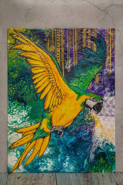 Hand made painting with color parrot on old light color table