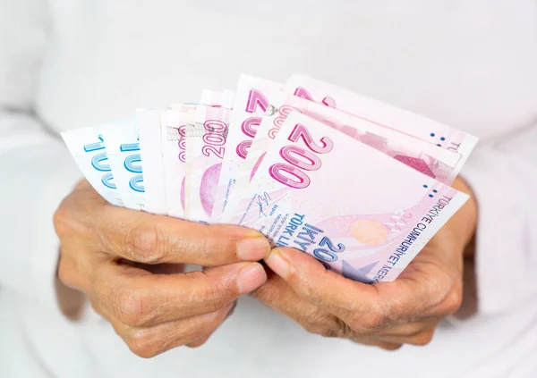 old women Hands holding Turkish Lira banknotes
