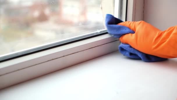 Un hombre lava la vieja ventana sucia. Elimina la cinta. — Vídeos de Stock