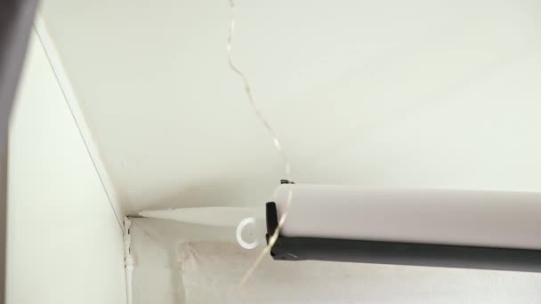 A man applies a sealant to the seam between the window and the sill from a tube of silicone sealant — Αρχείο Βίντεο