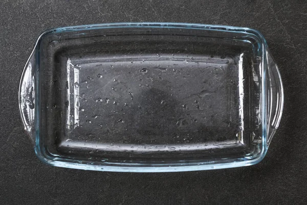 A baking dish cleaned from thick layer of carbon. Glassware for baking after washing with a steam Stock Photo