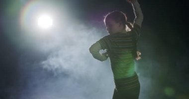 Genç bayan dansçı strobe light ve dumanla hip hop dansı yapıyor.