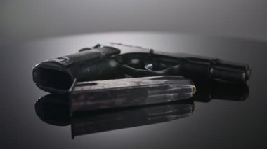 9mm gun rotating on a reflective surface