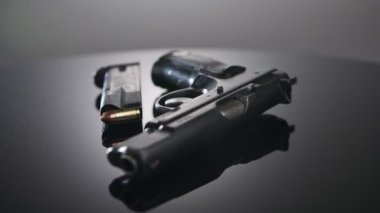 9mm gun rotating on a reflective surface