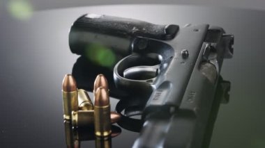 9mm gun rotating on a reflective surface
