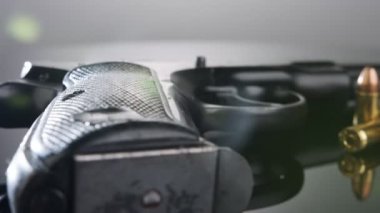 9mm gun rotating on a reflective surface
