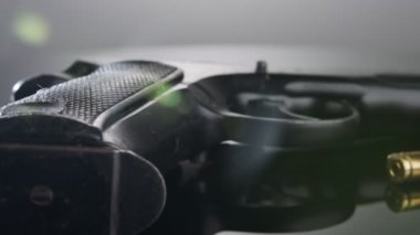 9mm gun rotating on a reflective surface