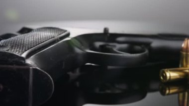 9mm gun rotating on a reflective surface