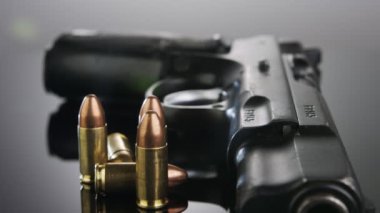 9mm gun rotating on a reflective surface