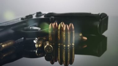 9mm gun rotating on a reflective surface