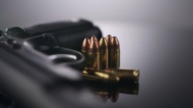 9mm gun rotating on a reflective surface
